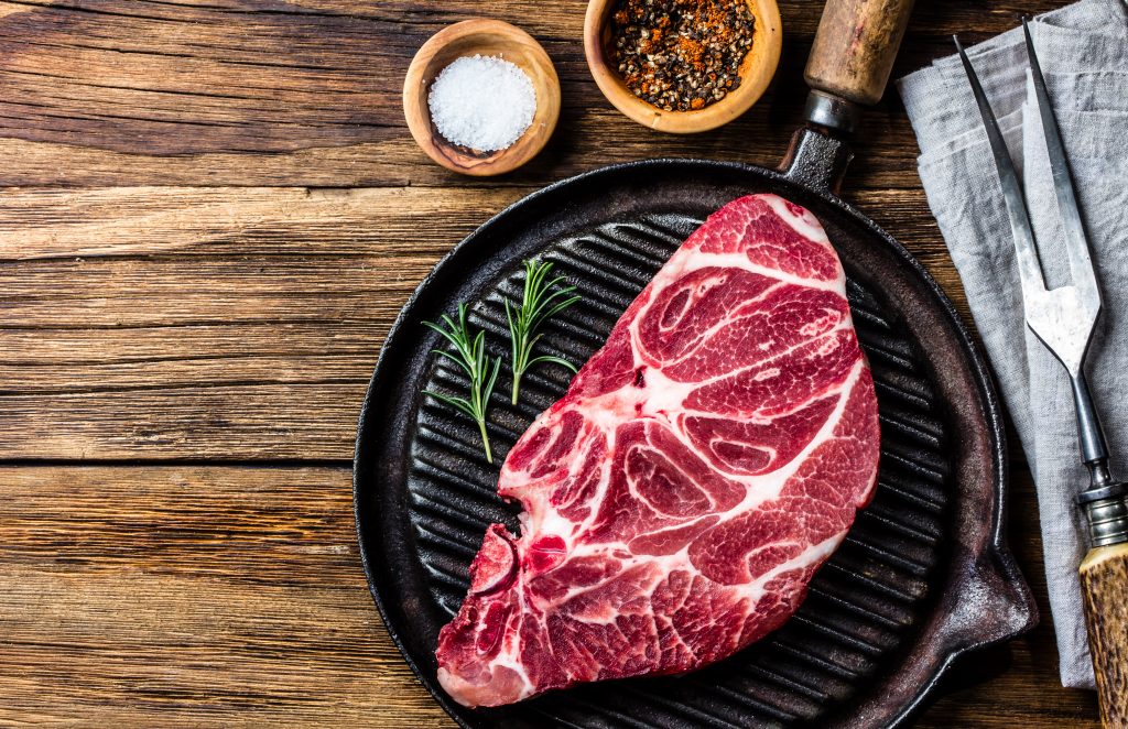 Raw marbled beef steak on grill pan